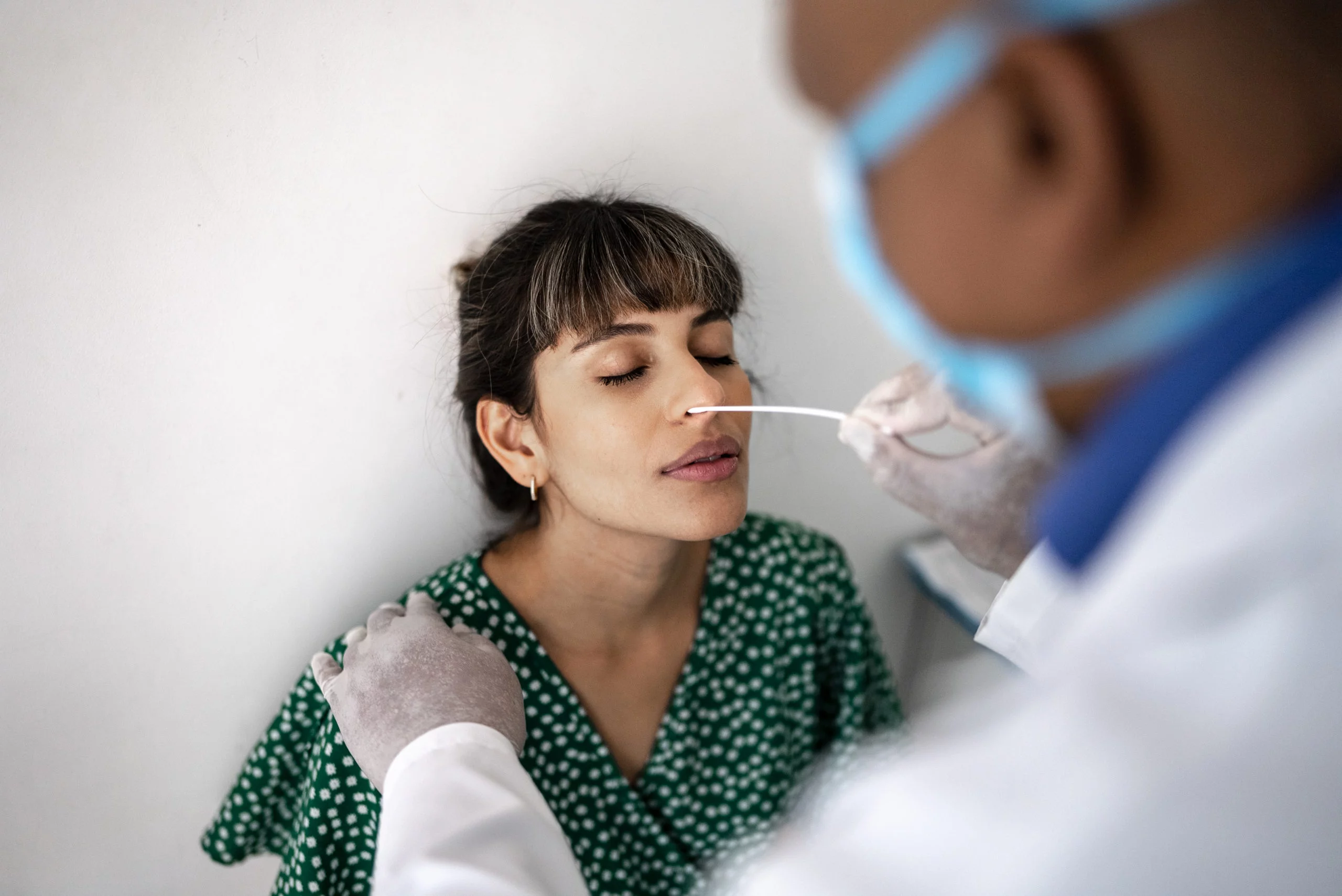 a woman being swabbed for covid