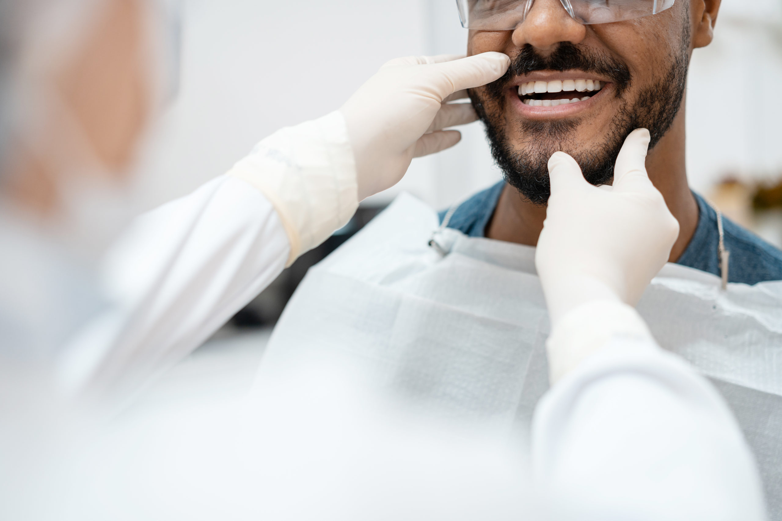 a dentist looking at a man's teeth