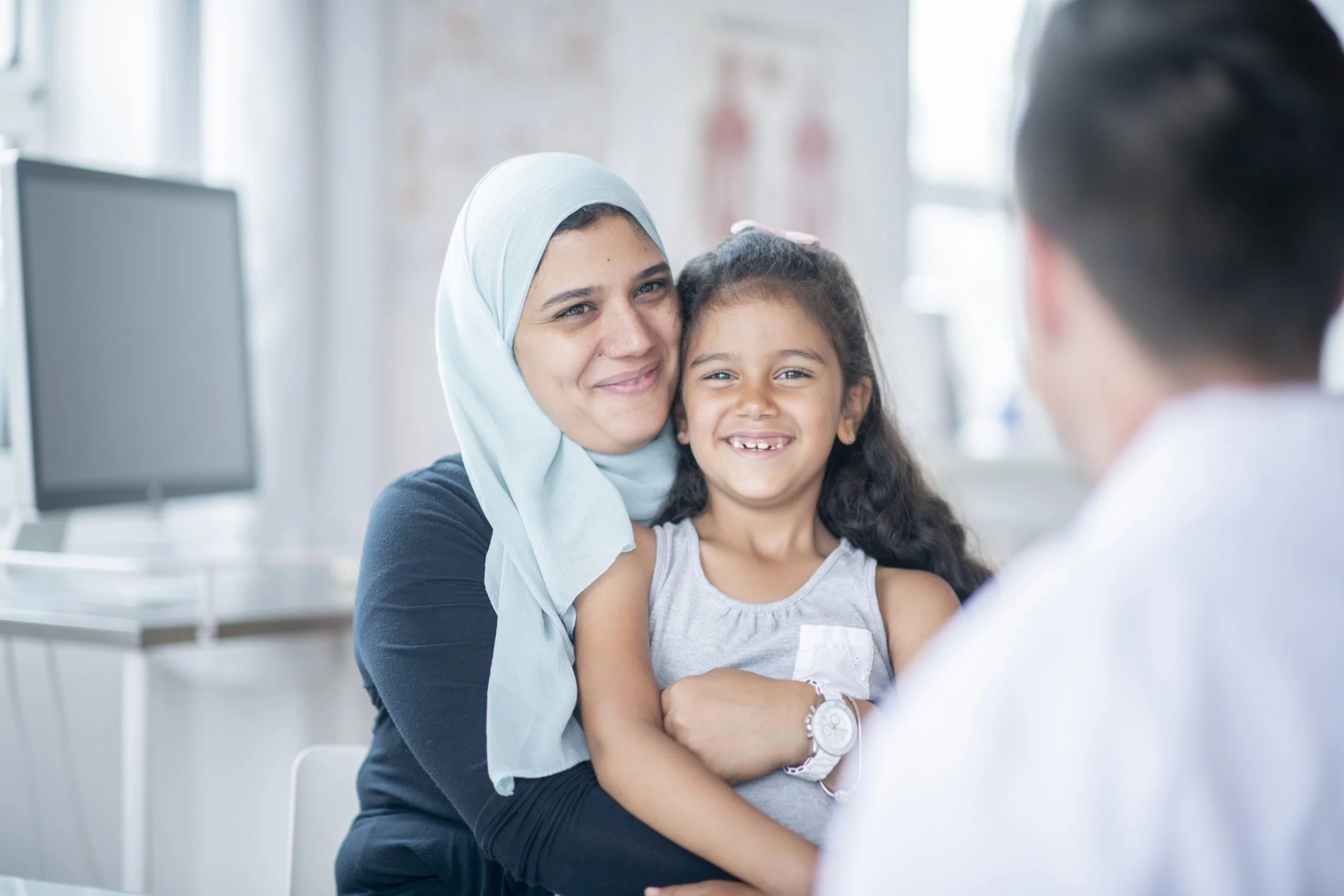 a woman holding a girl