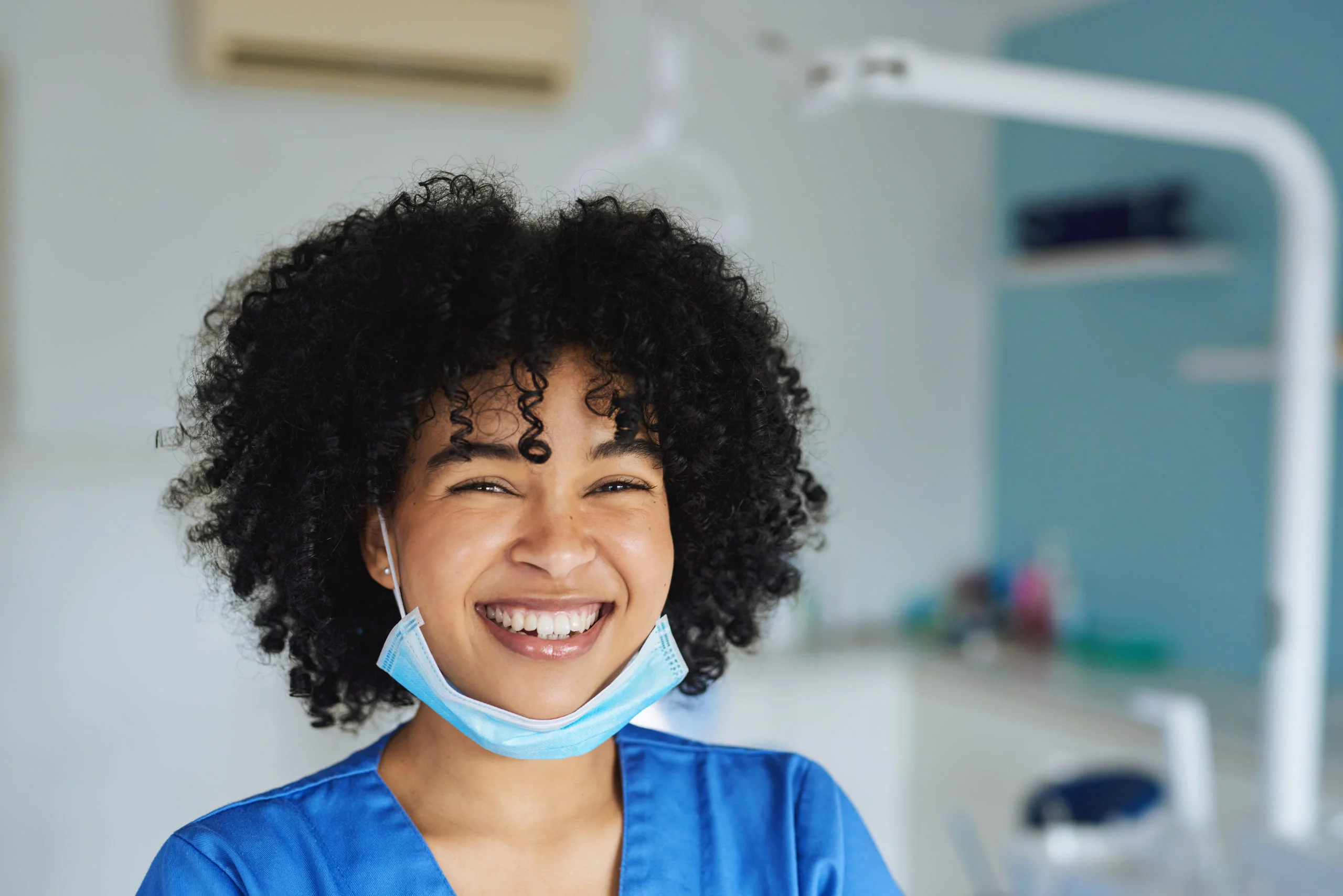 a woman in scrubs smiling